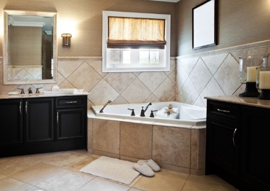 Classic bathroom renovation with brown tiles and corner tub in Townsville