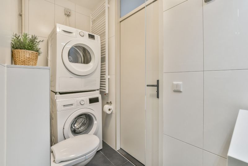 Renovated laundry with built-in cabinetry and bench space in a Townsville home